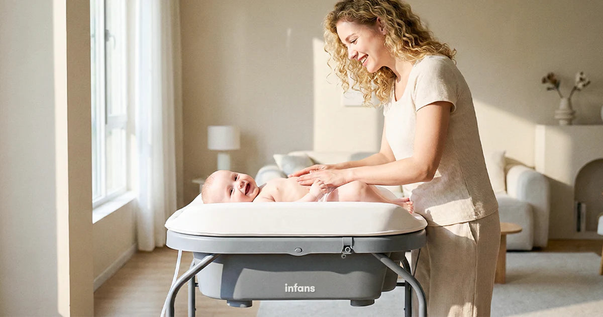 Woman tending to a baby in a bassinet in a bright room.